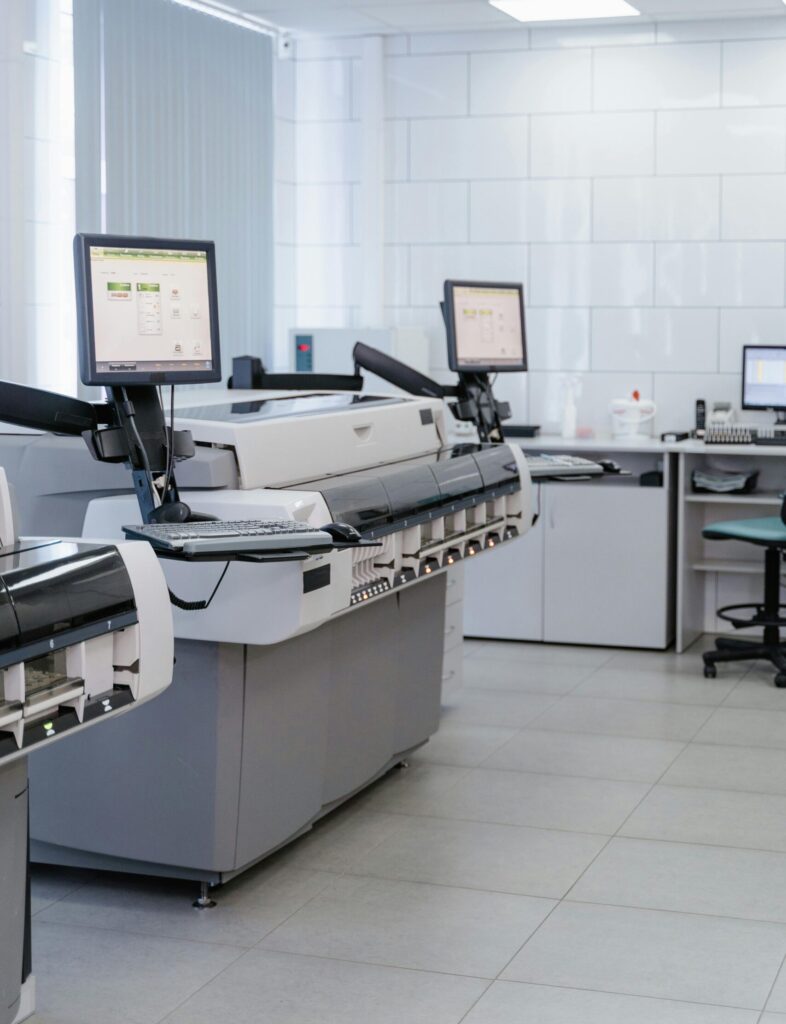 Bright and organized laboratory featuring high-tech printers and workstations.